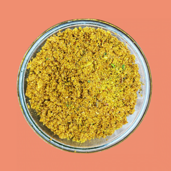 A photo of ZestBites Dry Prawns Chutney Powder in a transparent bowl, showcasing the product's texture and color, with a clean and simple background.